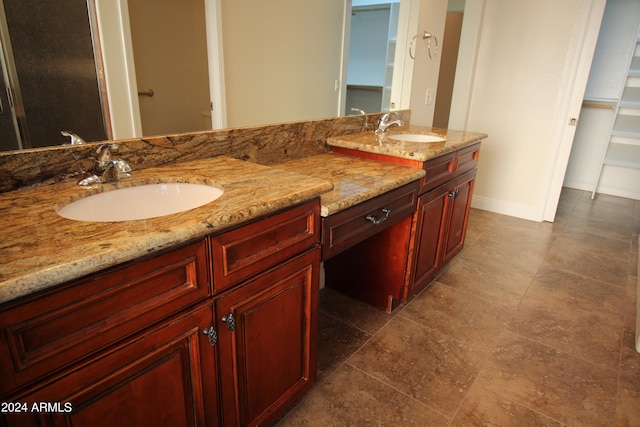 bathroom featuring tile patterned flooring and double sink vanity