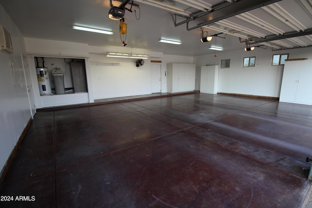 garage with a garage door opener and electric water heater