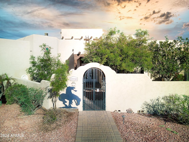 view of gate at dusk