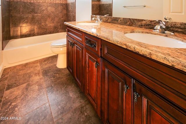 full bathroom with vanity, tiled shower / bath, and toilet