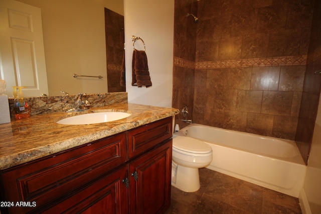 full bathroom with vanity, tile patterned flooring, tiled shower / bath combo, and toilet