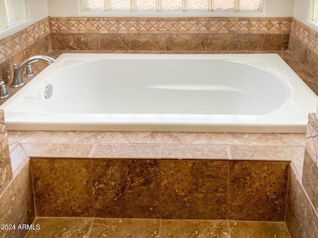 bathroom with tiled tub