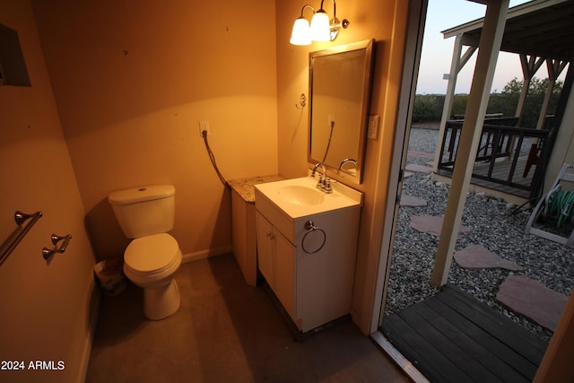 bathroom featuring vanity, a notable chandelier, and toilet