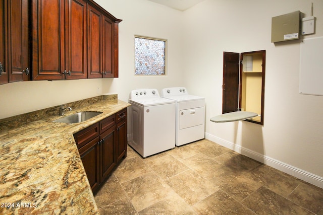 laundry room featuring sink, cabinets, and washing machine and clothes dryer