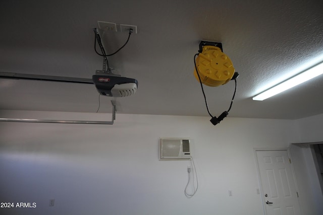 room details featuring a garage door opener and a textured ceiling