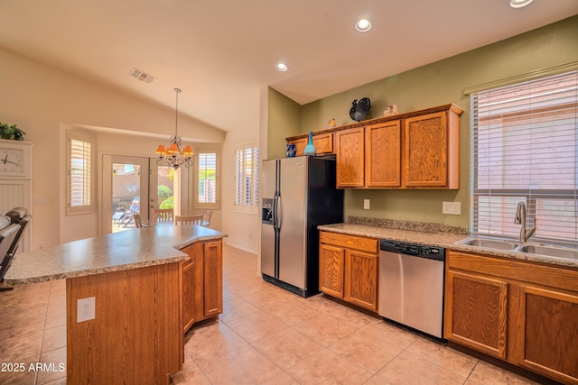 kitchen with a sink, visible vents, fridge with ice dispenser, dishwasher, and brown cabinetry