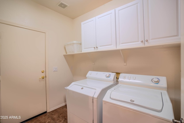 washroom featuring visible vents, dark tile patterned flooring, separate washer and dryer, and cabinet space