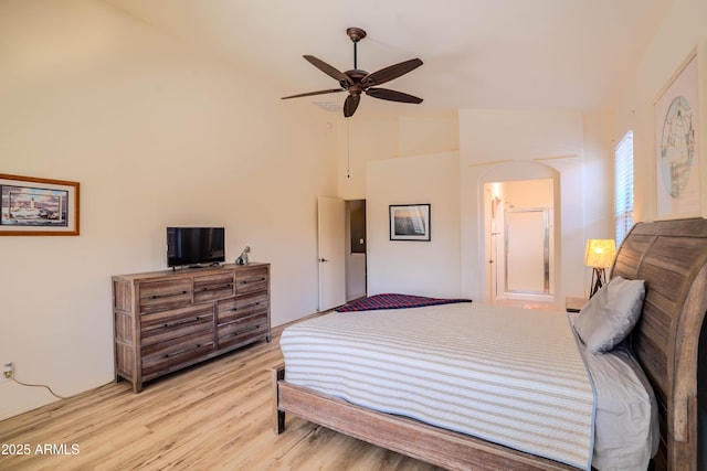 bedroom featuring light wood-type flooring, vaulted ceiling, and ceiling fan