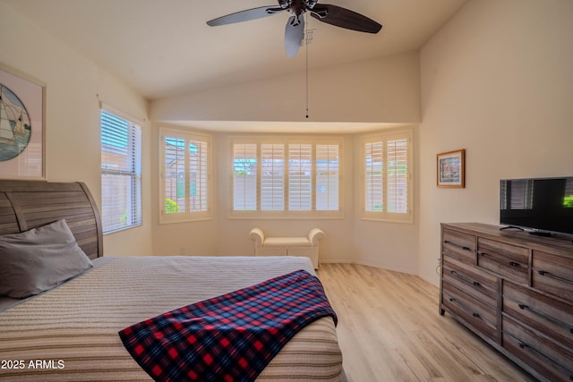 bedroom with ceiling fan, vaulted ceiling, and wood finished floors