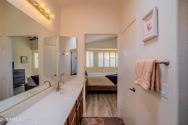 ensuite bathroom featuring a ceiling fan, a healthy amount of sunlight, and a sink