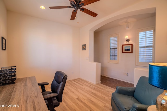 home office with arched walkways, recessed lighting, ceiling fan, wood finished floors, and baseboards