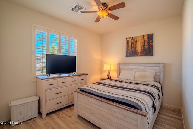 bedroom with ceiling fan, light wood finished floors, and visible vents