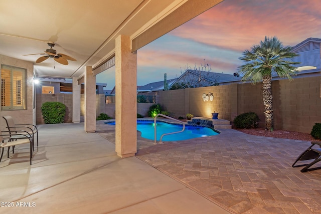 view of swimming pool featuring a fenced backyard, ceiling fan, a fenced in pool, and a patio