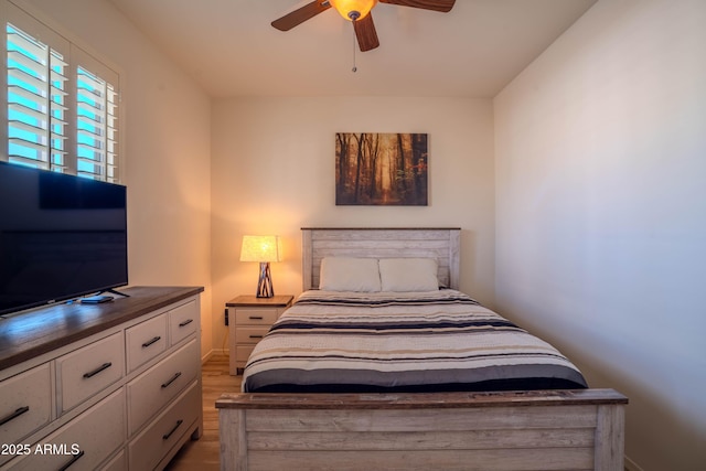 bedroom featuring a ceiling fan and wood finished floors