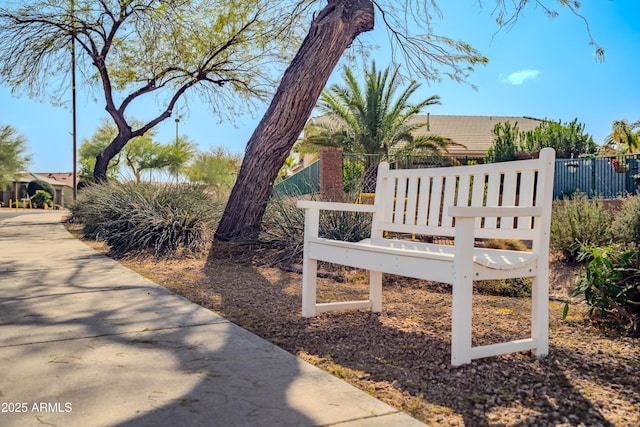 view of home's community featuring fence