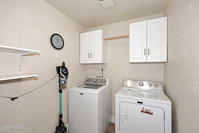 laundry room with cabinets and washing machine and dryer