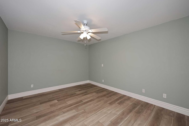 empty room featuring hardwood / wood-style flooring and ceiling fan