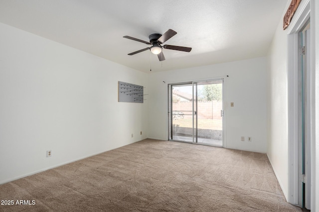 spare room with carpet flooring and ceiling fan