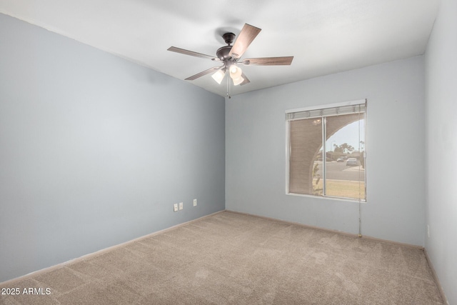 carpeted empty room with a ceiling fan