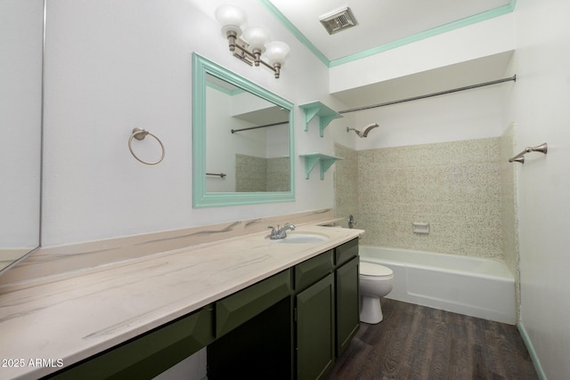 full bathroom with shower / washtub combination, visible vents, toilet, vanity, and wood finished floors