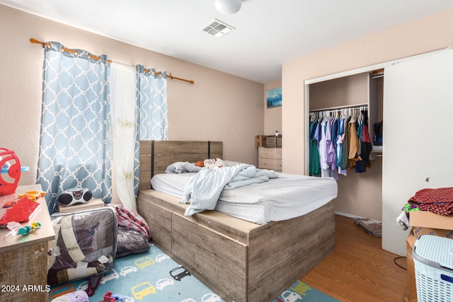 bedroom with a closet and hardwood / wood-style flooring