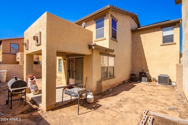 back of house with a patio area and central AC