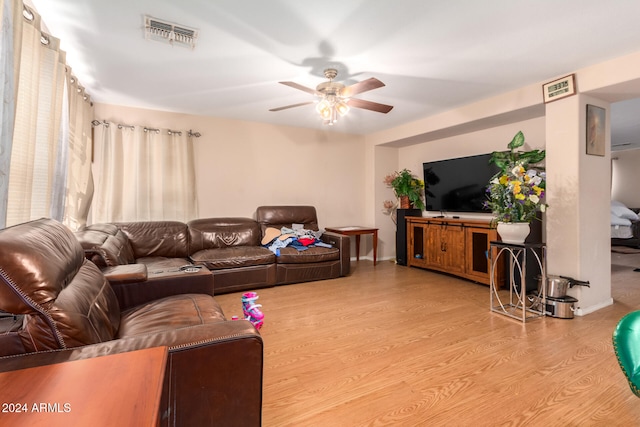 living room featuring light wood-type flooring and ceiling fan