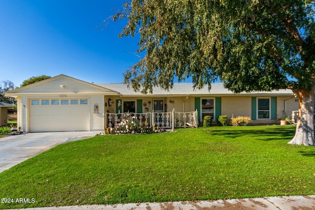 ranch-style home with a garage and a front yard