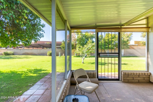 unfurnished sunroom featuring lofted ceiling