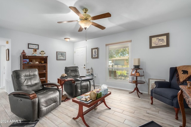 living room with ceiling fan and light hardwood / wood-style floors