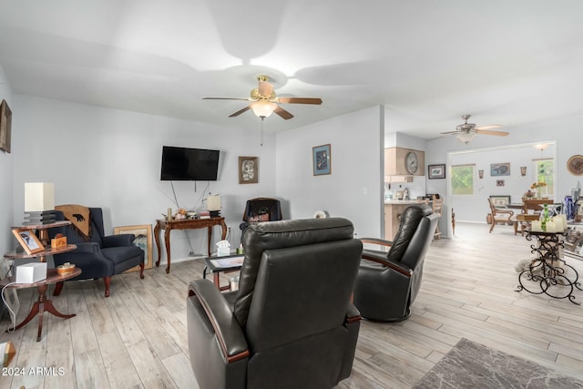 living room featuring ceiling fan and light wood-type flooring