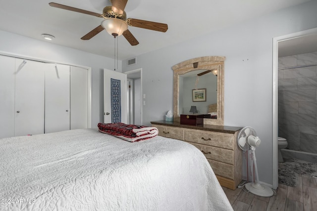 bedroom featuring a closet, light wood-type flooring, ensuite bathroom, and ceiling fan