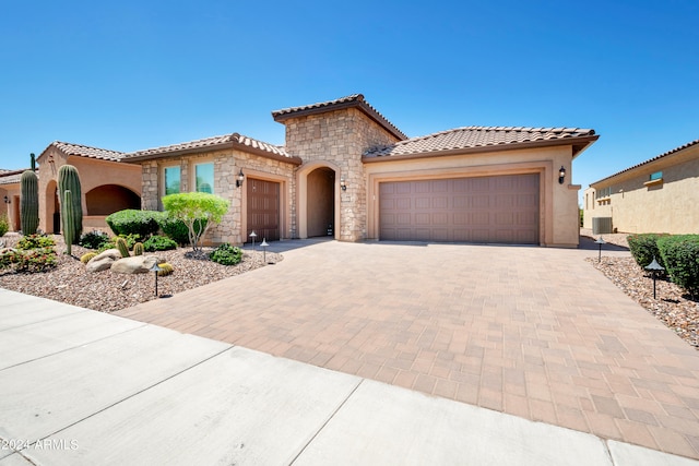 mediterranean / spanish-style house with a garage