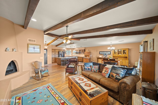 living room featuring beamed ceiling, light wood-type flooring, and ceiling fan with notable chandelier