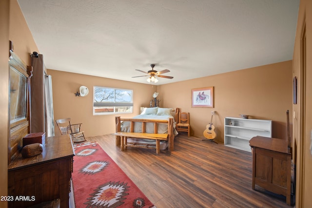 bedroom with ceiling fan and dark wood-type flooring