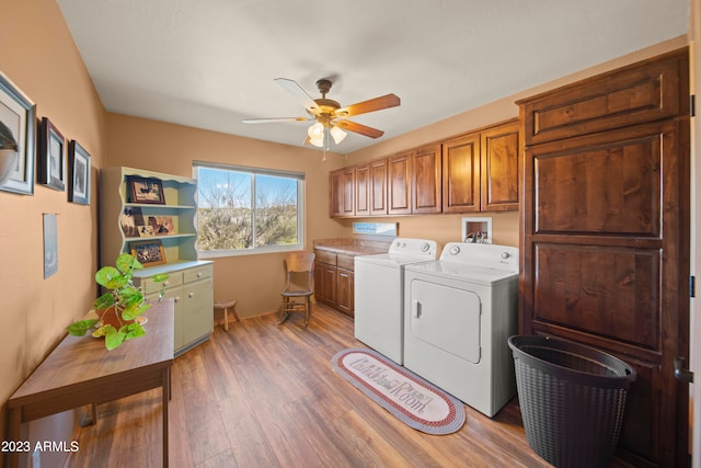 washroom with cabinets, hardwood / wood-style floors, ceiling fan, and washing machine and clothes dryer