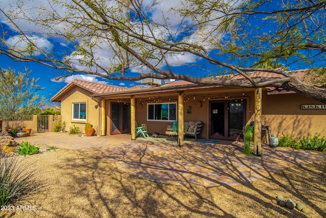 rear view of house with a patio