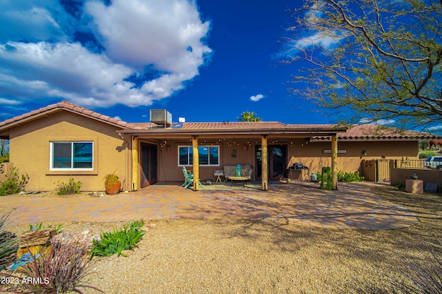 rear view of house with cooling unit and a patio area