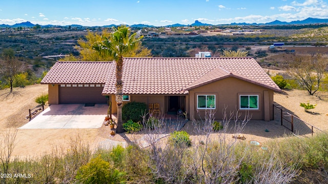 view of front of home featuring a mountain view and a garage