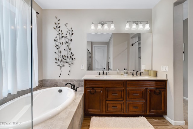 4422 W Adobe Dr, Eloy, AZ 85131 - full bathroom featuring a garden tub, double vanity, and wood finished floors