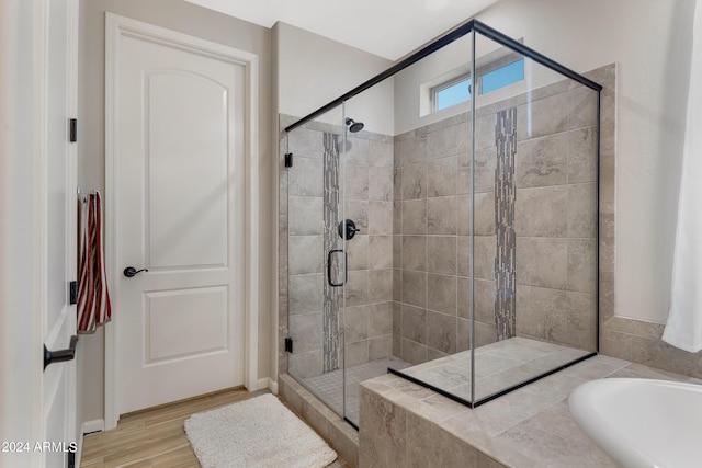 4422 W Adobe Dr, Eloy, AZ 85131 - bathroom featuring a shower stall, a bath, and wood finished floors