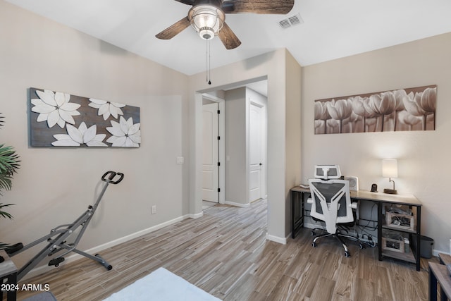 home office with light hardwood / wood-style flooring and ceiling fan