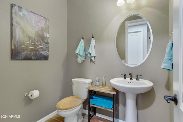 bathroom featuring hardwood / wood-style floors, sink, and toilet