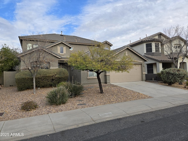 traditional-style home featuring driveway, an attached garage, a tile roof, and stucco siding