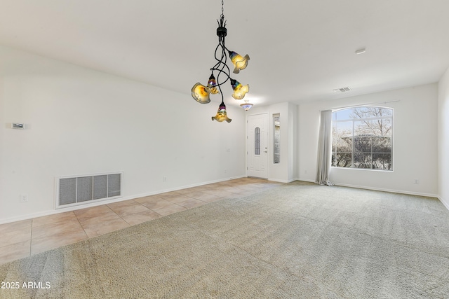 tiled spare room featuring carpet floors, visible vents, and baseboards