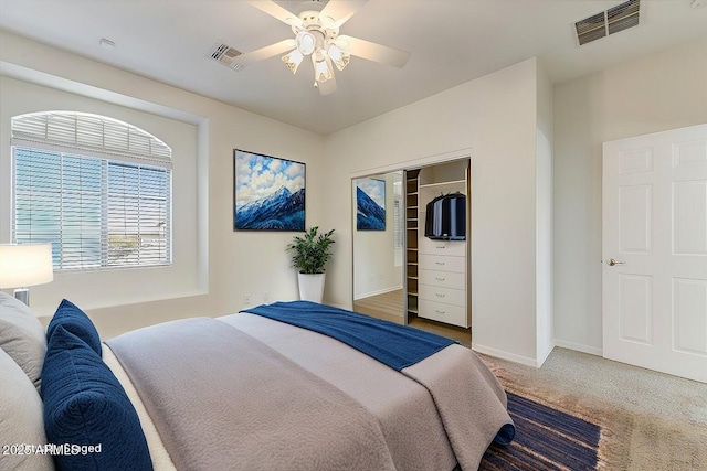 bedroom with carpet floors, baseboards, visible vents, and a closet