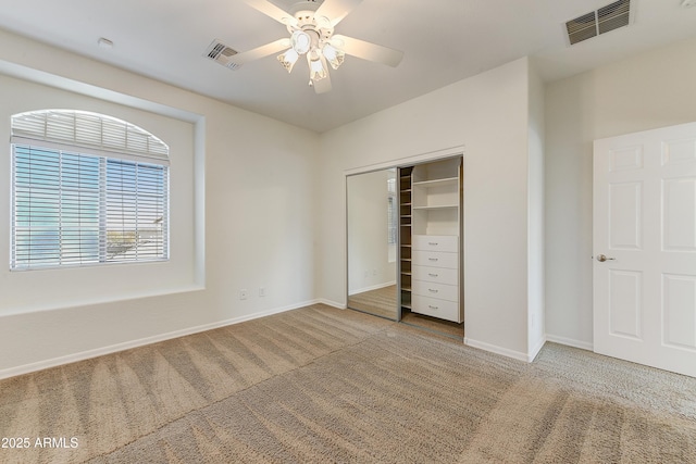 unfurnished bedroom featuring carpet floors, a closet, visible vents, and baseboards