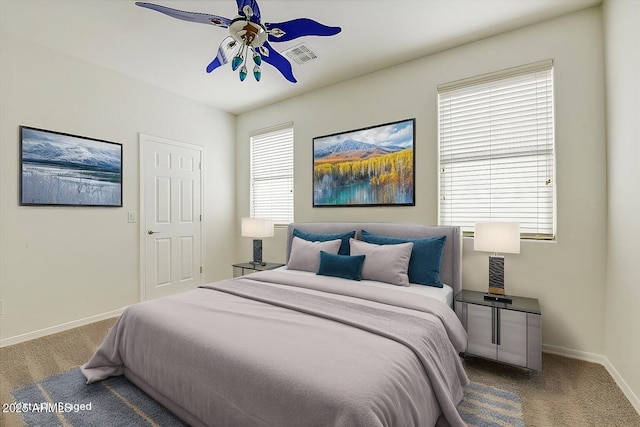 carpeted bedroom with multiple windows, ceiling fan, visible vents, and baseboards