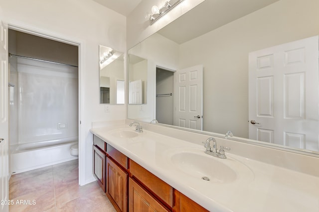 bathroom with tile patterned flooring, bathtub / shower combination, a sink, and double vanity