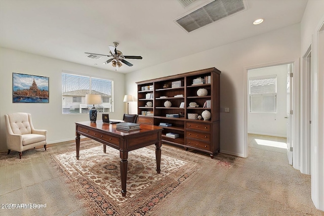 office space featuring ceiling fan, recessed lighting, light carpet, visible vents, and baseboards